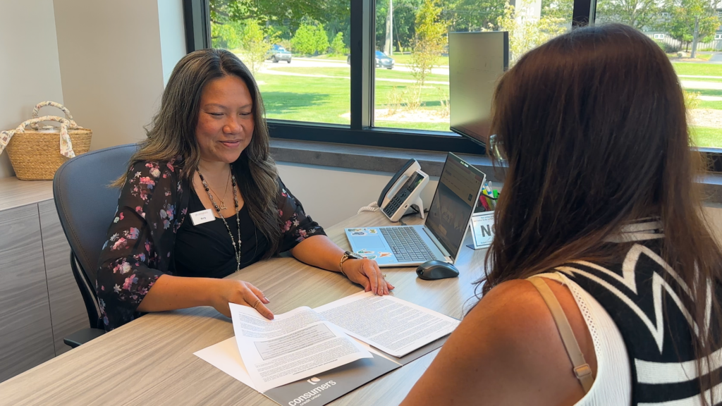 Molly Phan meeting with a member at a Consumers Credit Union office.