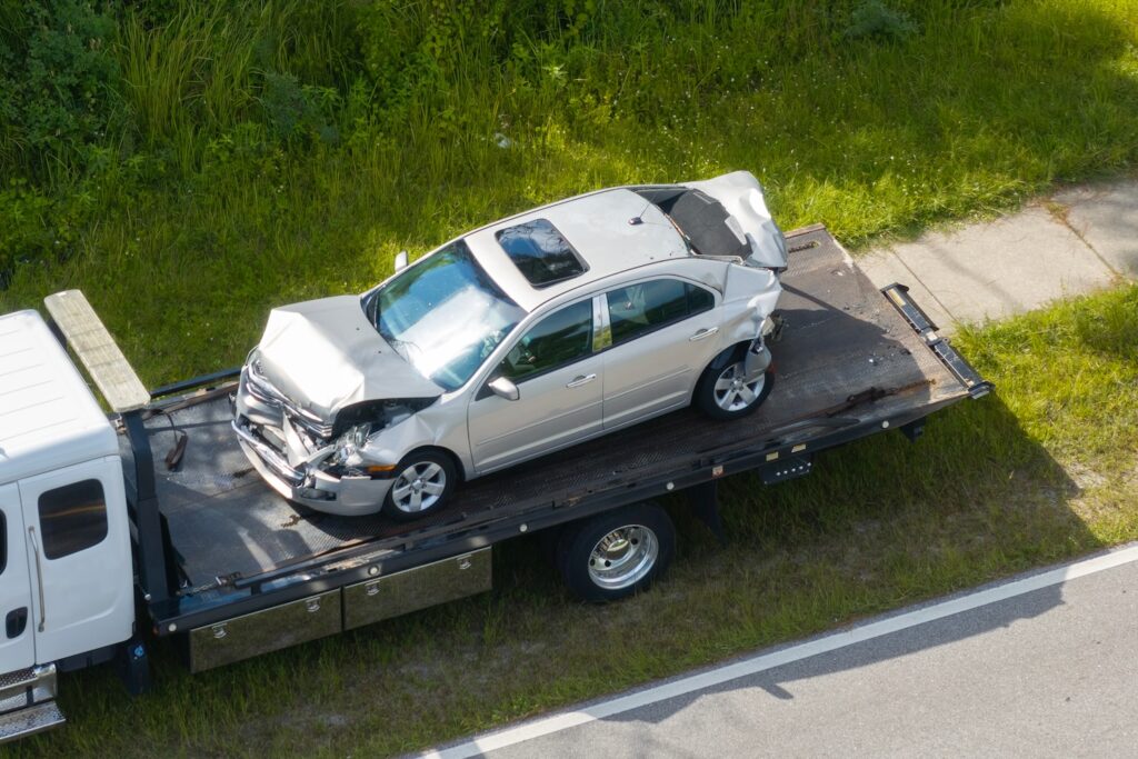 Totaled car sitting on a tow truck.