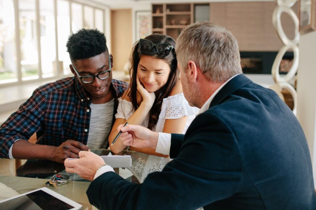 Real estate agent going over paperwork with a couple