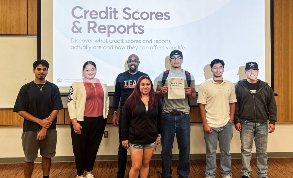 Financial Education Outreach Coordinator Myron poses with WMU students after a presentation on credit scores and credit reports.