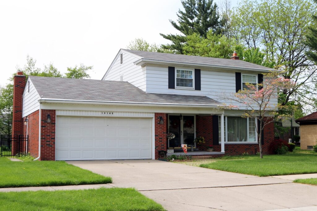 House in Michigan with brick and white siding.