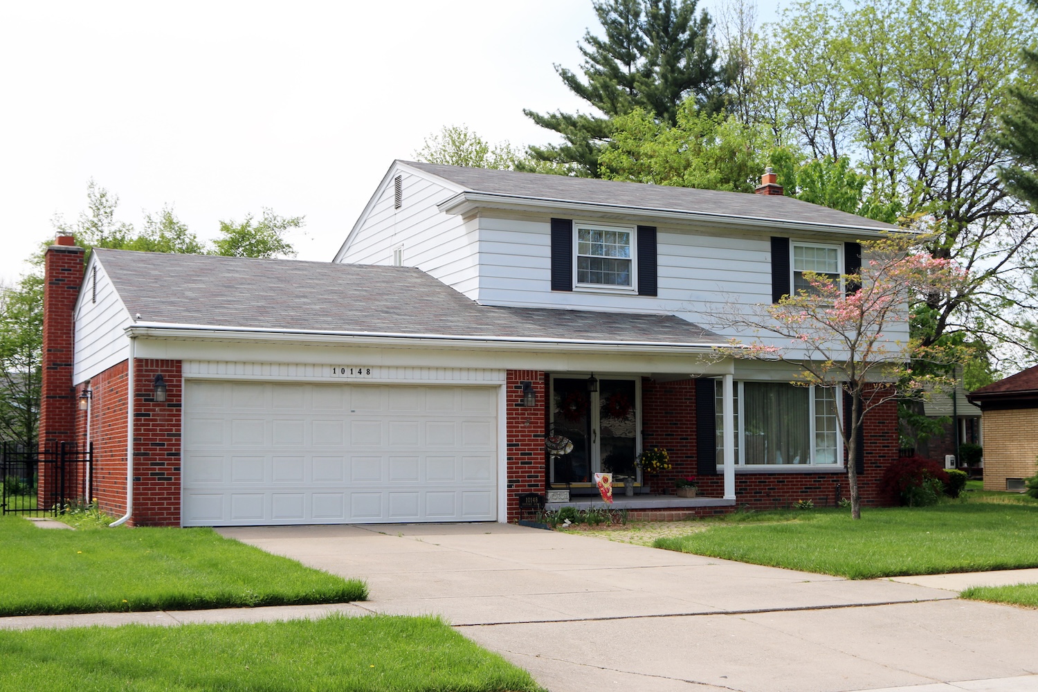House in Michigan with brick and white siding.