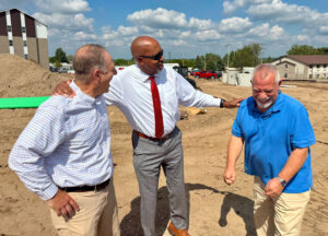 Fred Guenther, Mark Gifford and Dr. Pink standing together and laughing.